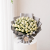 Ivory rose bouquet with fresh white roses and elegant silver wrapping Ivory rose bouquet with fresh white roses and elegant silver wrapping
