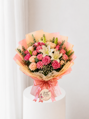 Peach floral bouquet with pink flowers and white lilies