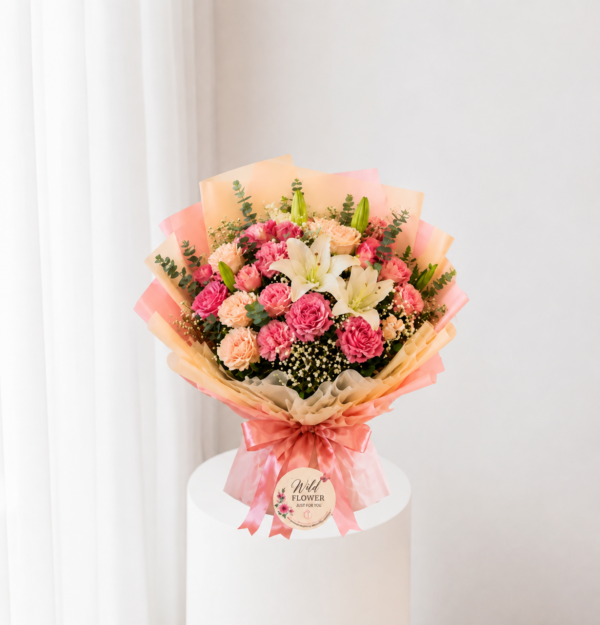 Peach floral bouquet with pink flowers and white lilies