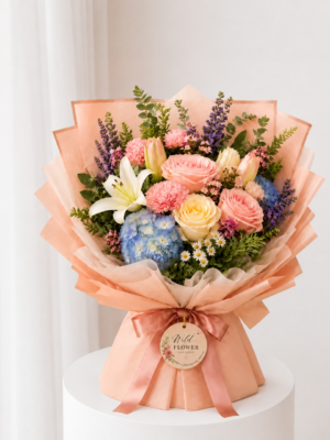 Peach Mixed Bouquet with roses white lilies blue hydrangea and peach wrapping