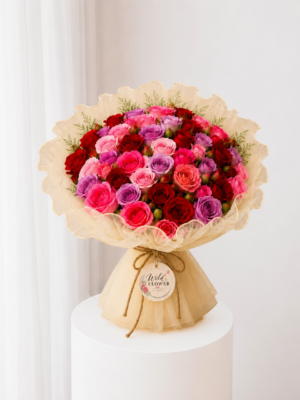 Ruby Rose Bouquet with red and pink roses in cream wrapping