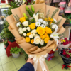 Handheld Bouquet in a Florist Shop Golden Lily Mix